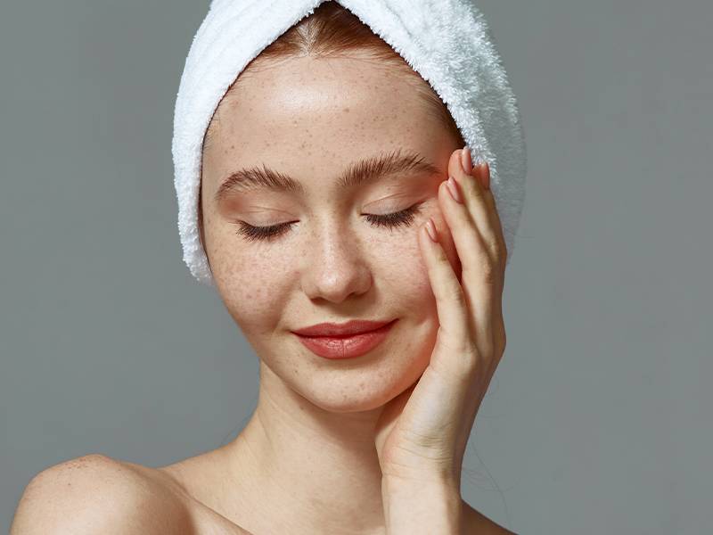 person posing with towel on head